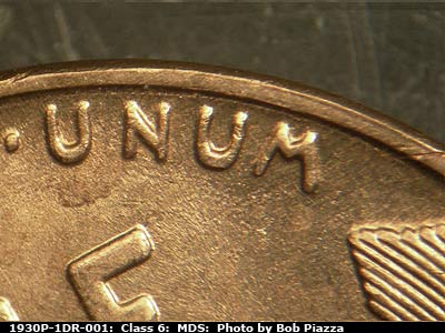 Die-stage B marker on 1930P•1DR•001 showing Extra thickness on UNUM with an elongated dot.