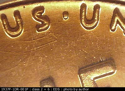 Die-stage A marker on 1937P•1DR•001P showing A set of very distinctive die scratchers show below the US of Pluribus.