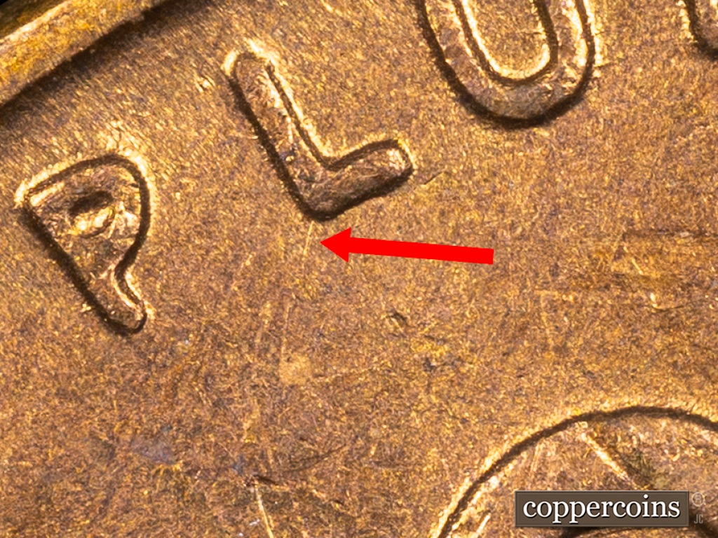 Die-stage E marker on 1938S•1MM•001 showing Die Scratch of L of PLURIBUS.