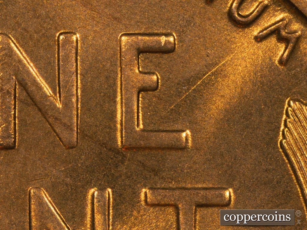 Die-stage B marker on 1938S•1MM•001 showing Die Gouge is clearly visible above and below the E of ONE.