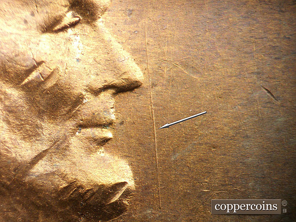 Die-stage B marker on 1941D•1DO•002 showing Heavy N/S die scratch in field in front of nose.