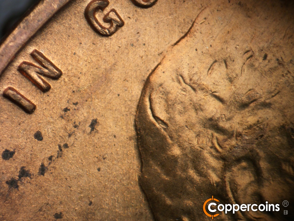 Die-stage A marker on 1942S•1DO•004 showing Light N/S die scratches in back of head.
