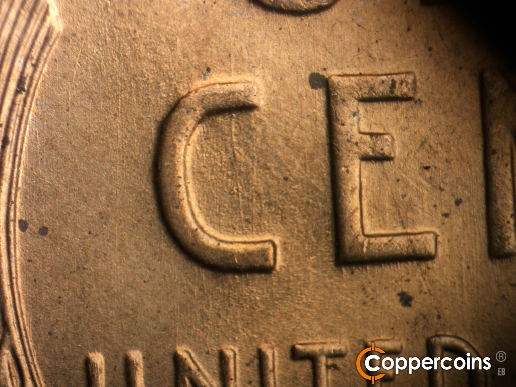 Die-stage A marker on 1942S•1DO•004 showing N/S die scratches through CE in CENT.