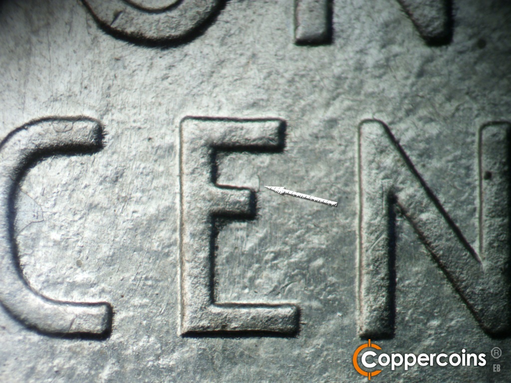Die-stage A marker on 1943D•1MM•002 showing Die gouge from middle leg of E in CENT.