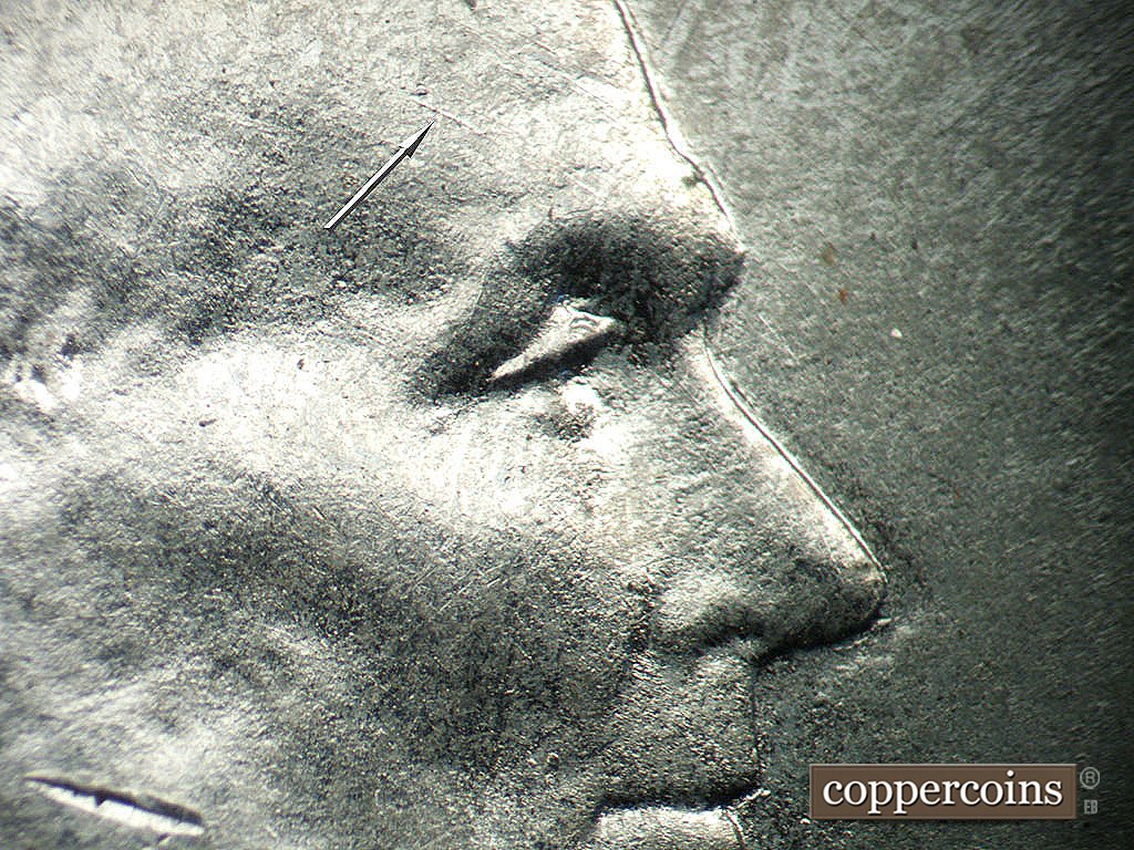 Die-stage A marker on 1943P•1DO•031 showing SE die scratch on forehead.