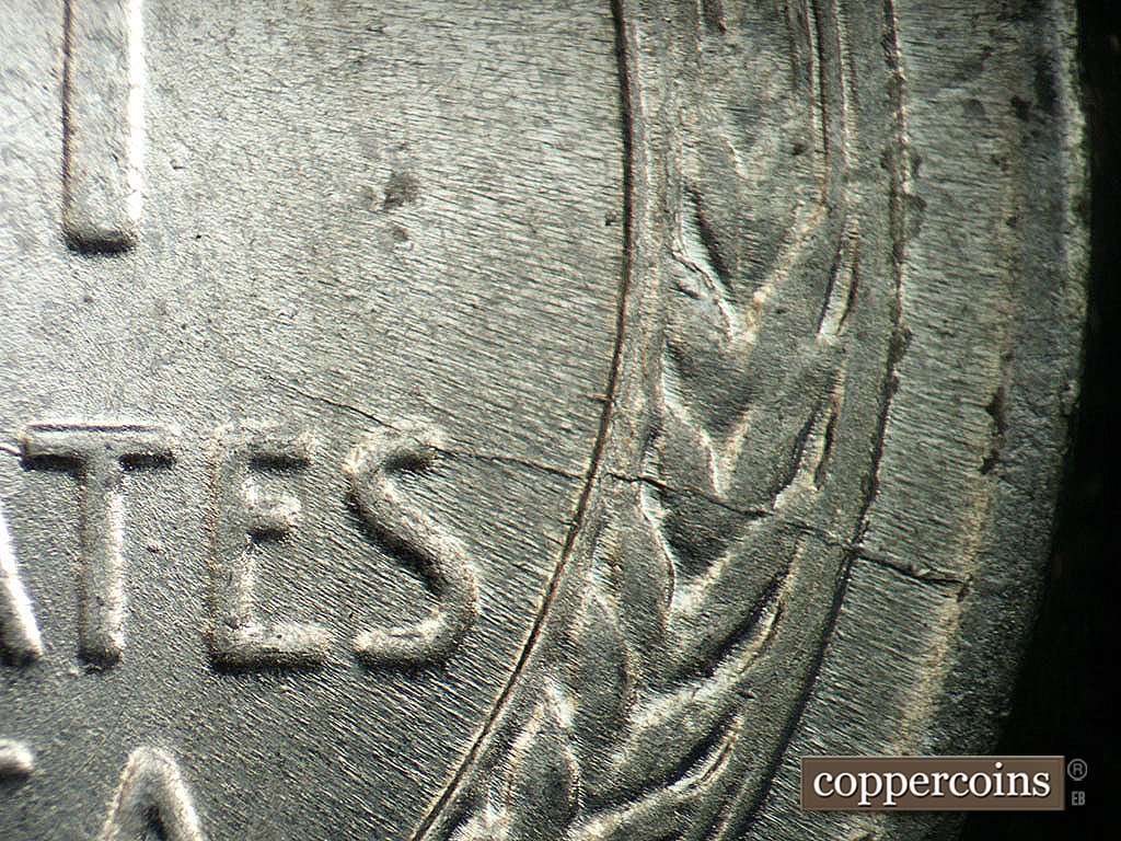 Die-stage A marker on 1943P•1DO•031 showing Die crack from rim though last S in STATES.