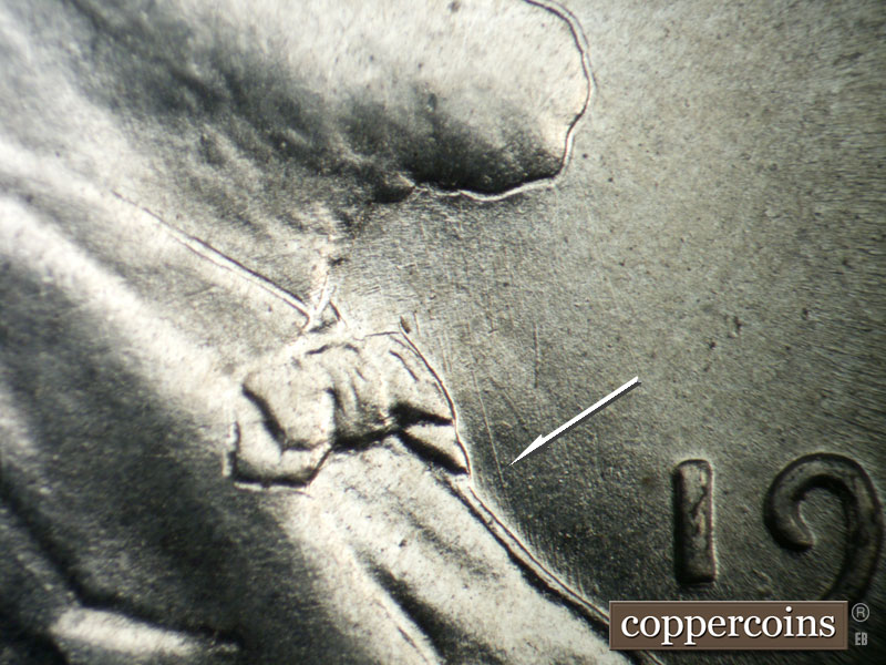 Die-stage B marker on 1943P•1DO•031 showing NNW die scratch in front of bowtie.