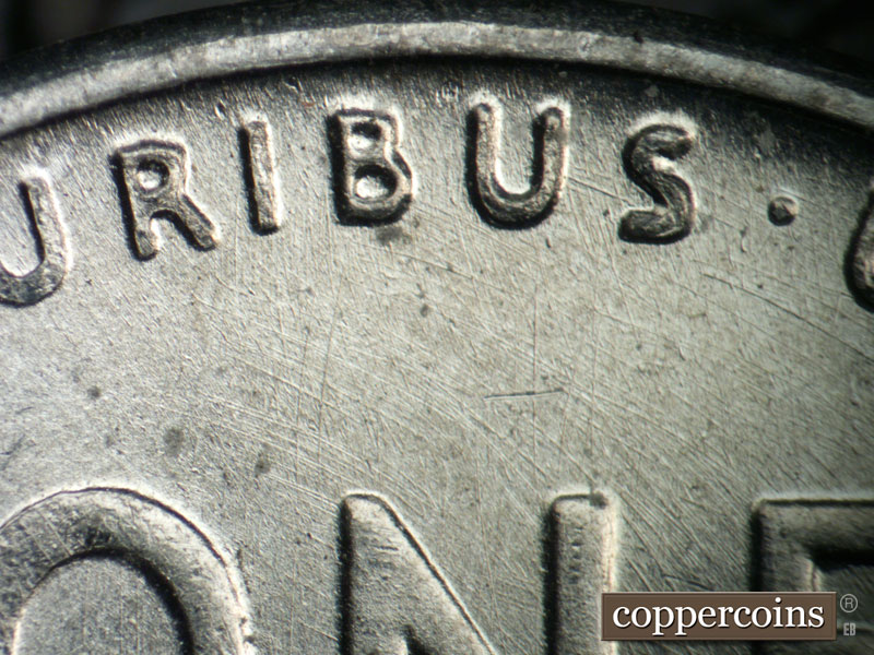 Die-stage B marker on 1943P•1DO•031 showing Curved die scratches through PLURIBUS and ONE.
