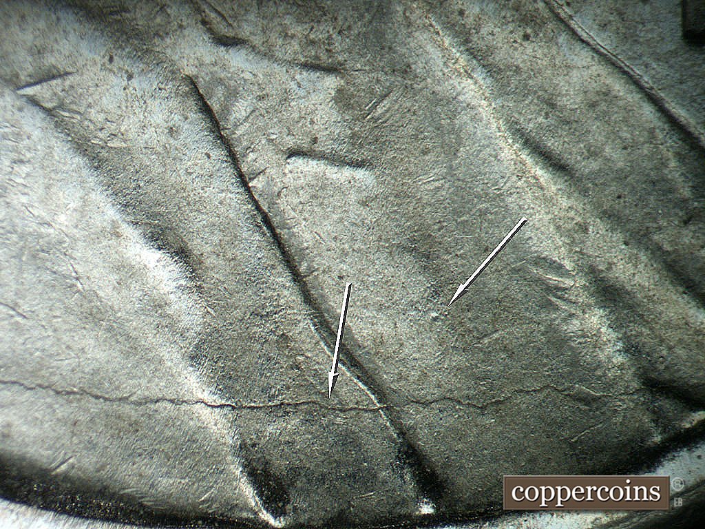 Die-stage B marker on 1943P•1DO•036 showing Die crack from shoulder through lapel.
