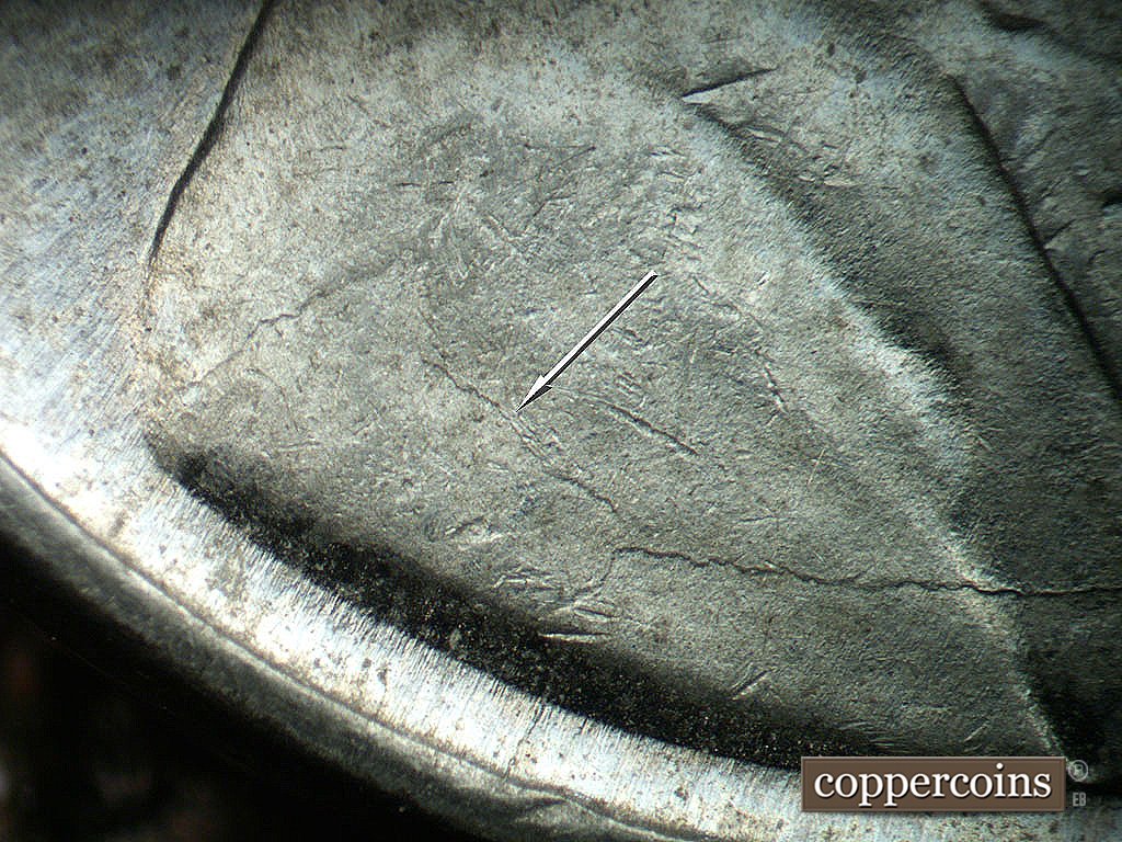 Die-stage B marker on 1943P•1DO•036 showing Die crack on shoulder.