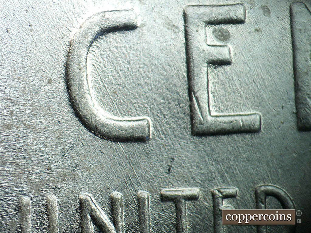 Die-stage B marker on 1943P•1DO•039 showing SE die scratch in C of CENT.