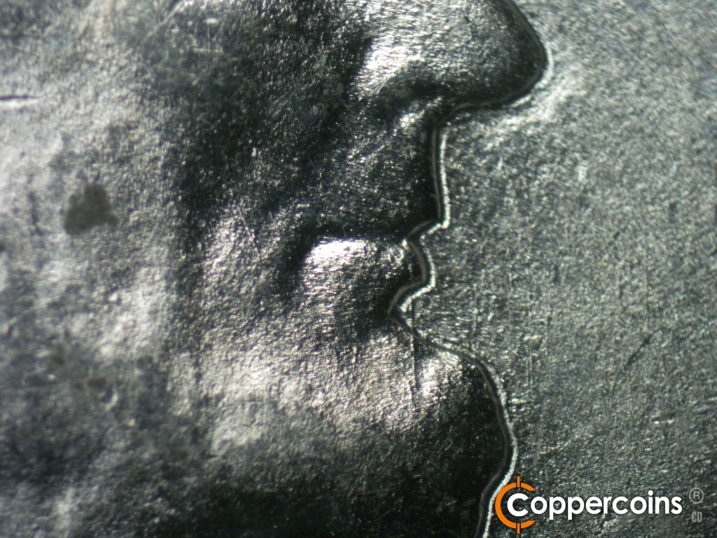 Die-stage B marker on 1943P•1DO•040 showing Small die scratch runs generally N-S to the left of the mouth. Another longer N-S die scratch shows in front of the lip.