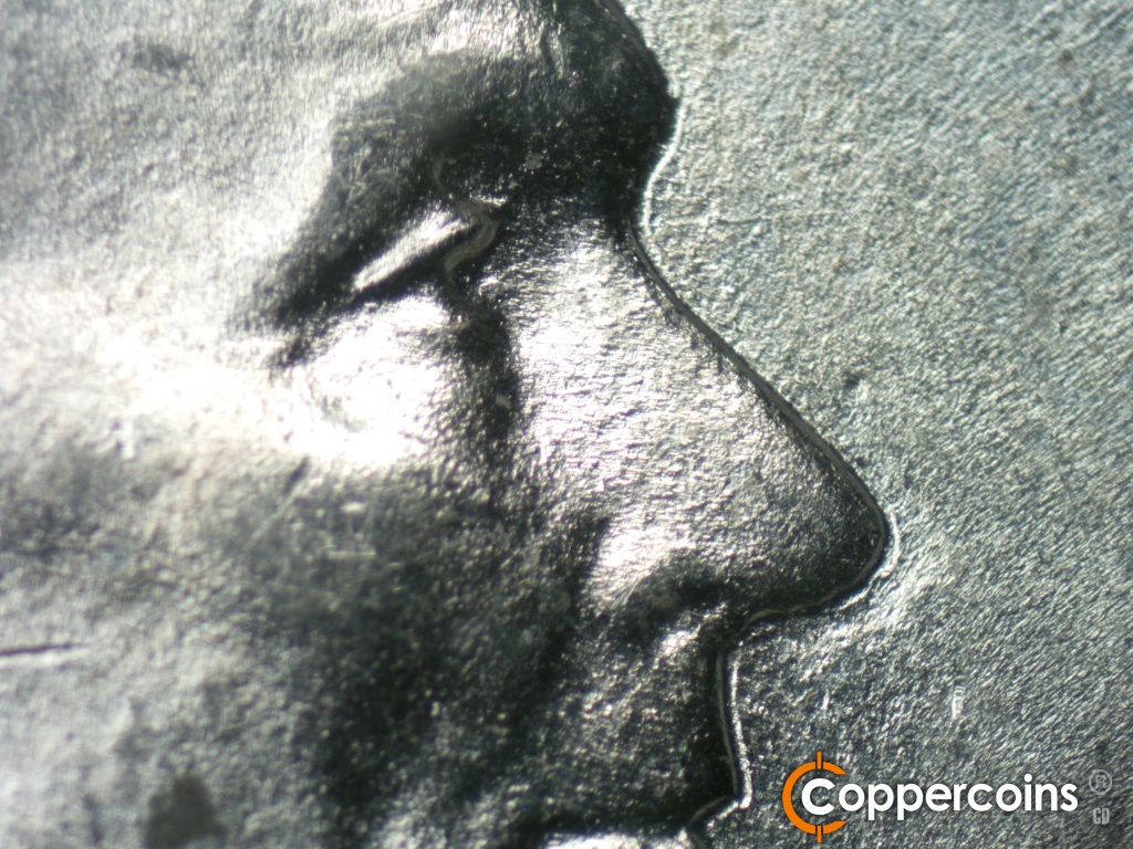 Die-stage B marker on 1943P•1DO•040 showing Doubled eyelid shows moderately and closely hubbed inside the primary eye.