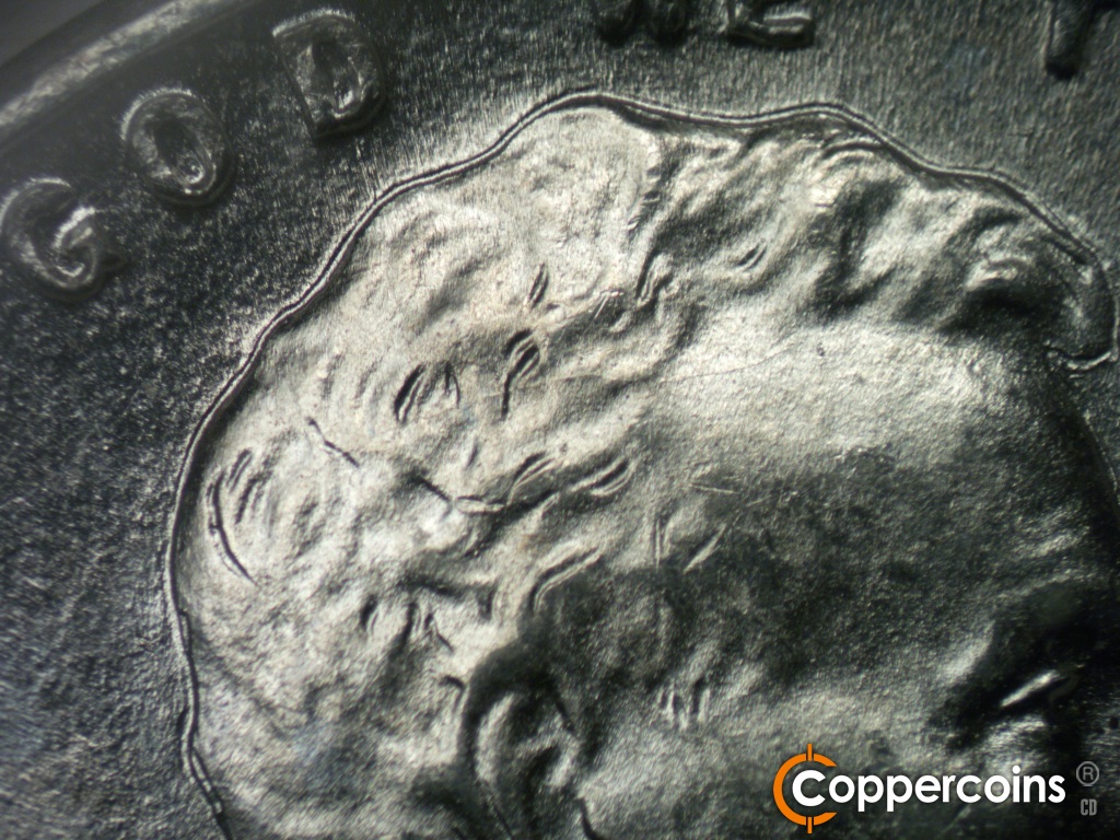 Die-stage B marker on 1943P•1DO•040 showing Die crack runs across the hair.