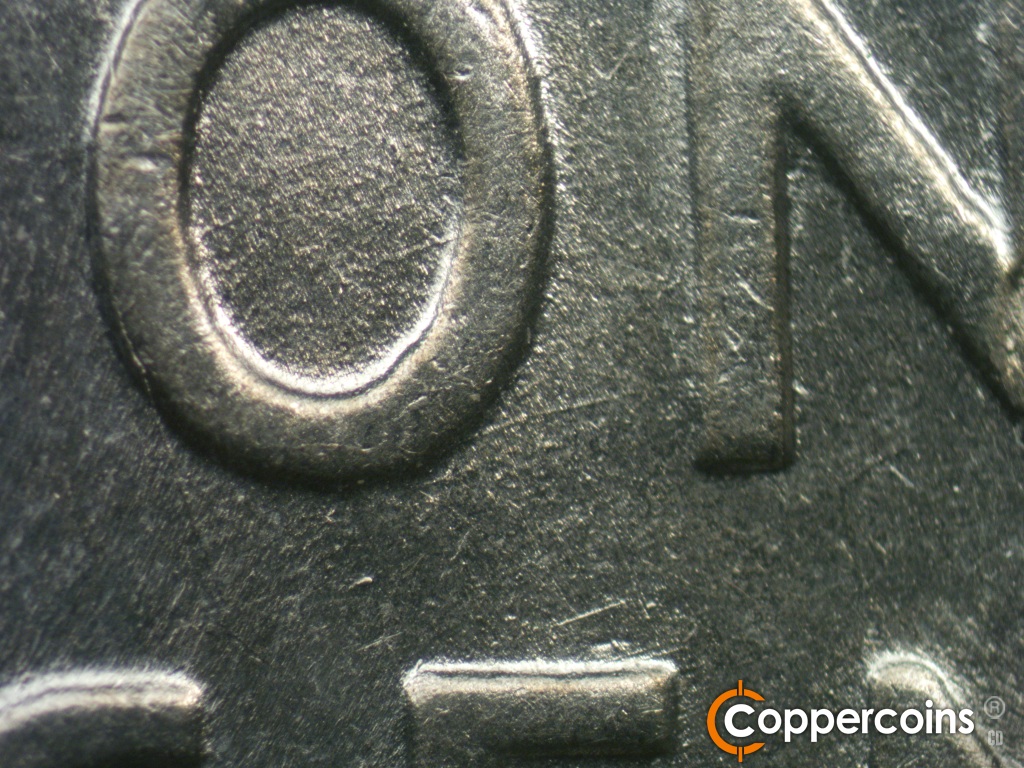 Die-stage B marker on 1943P•1DO•040 showing Concentric die scratches show in the O and N of ONE.