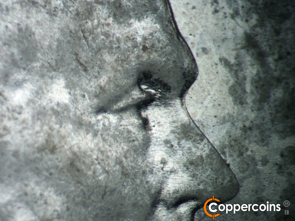 Die-stage C marker on 1943S•1DO•014 showing Closeup of extra upper eyelid to the north.