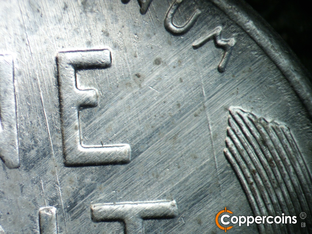Die-stage C marker on 1943S•1DO•014 showing Heavy SSE die gouge between NE in ONE and from bottom of M in UNUM.