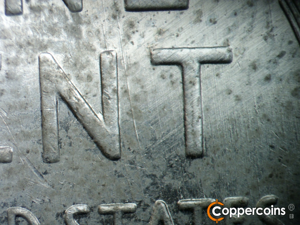 Die-stage C marker on 1943S•1DO•014 showing Heavy SSE die gouge between NT in CENT.