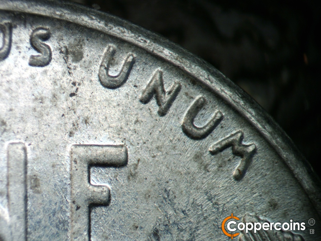 Die-stage A marker on 1943S•1DR•006 showing Extra thickness on UNUM.