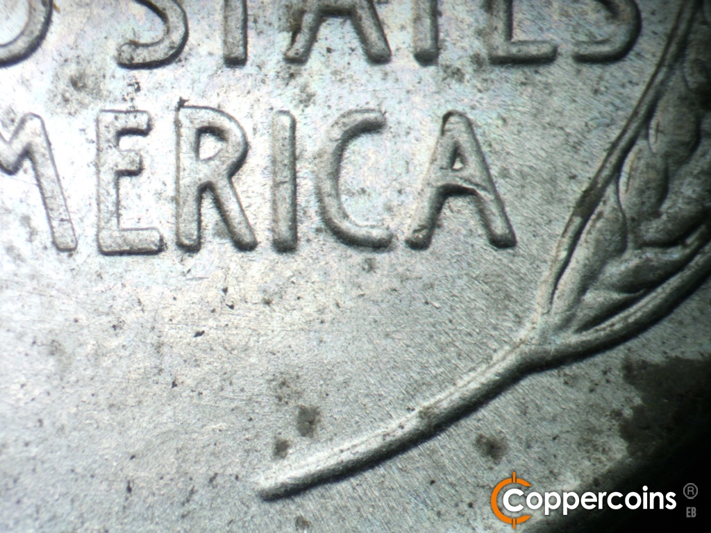 Die-stage A marker on 1943S•1DR•006 showing Light die scratches under AMERICA.