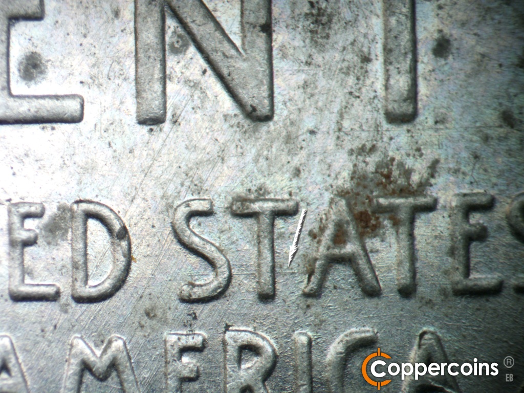 Die-stage A marker on 1943S•1DR•006 showing E/W die scratch through STA in STATES.