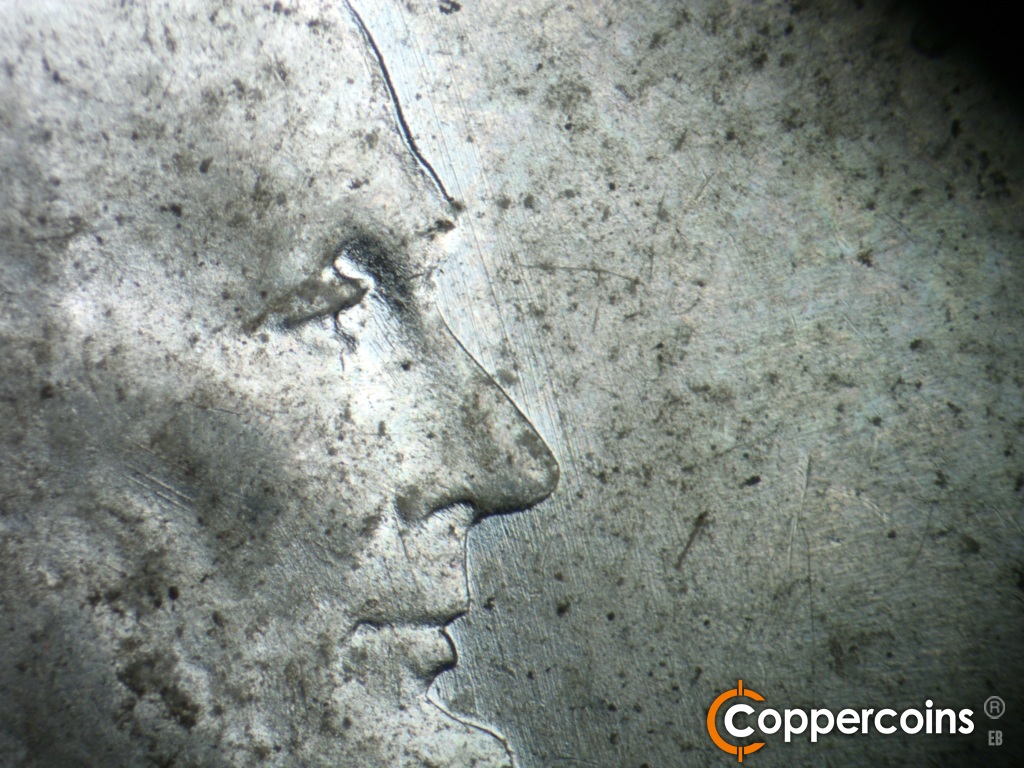 Die-stage A marker on 1943S•1DR•006 showing NNW die scratches in front of face.