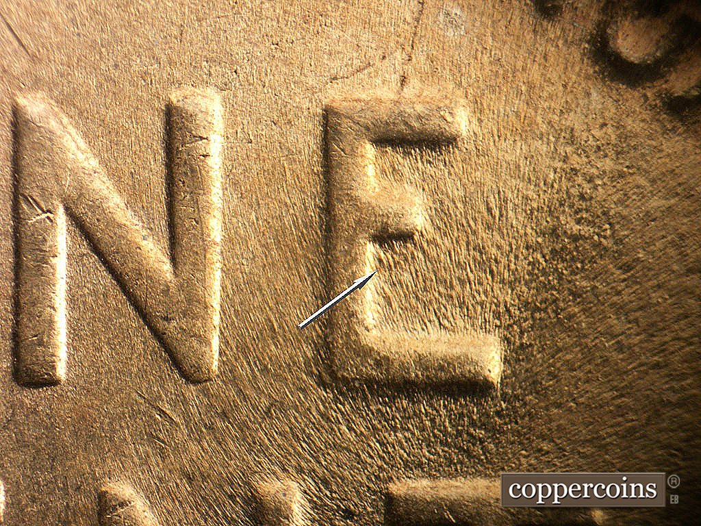 Die-stage C marker on 1944D•1DO•001 showing Die gouge in lower E of ONE.