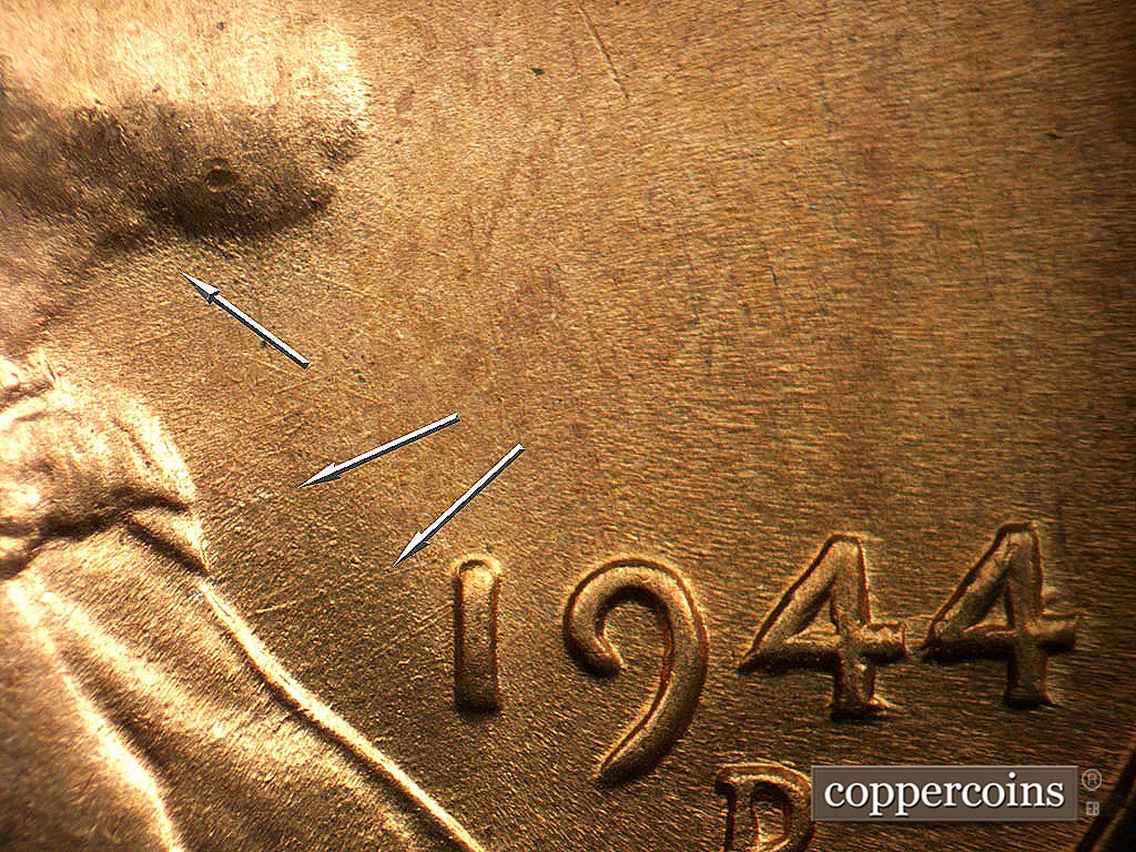 Die-stage B marker on 1944D•1MM•024 showing Light die scratches below the chin, protruding from the bow tie, and to the west of the 1 of the date.