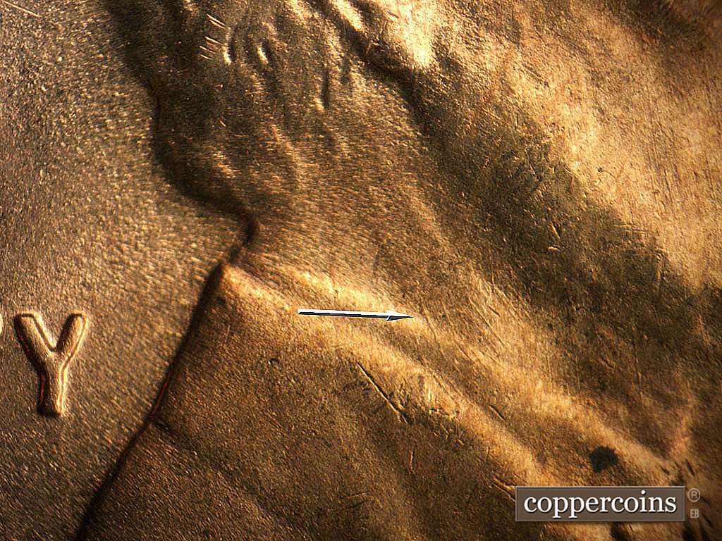 Die-stage B marker on 1944D•1MM•024 showing Die scratches on neck and collar.