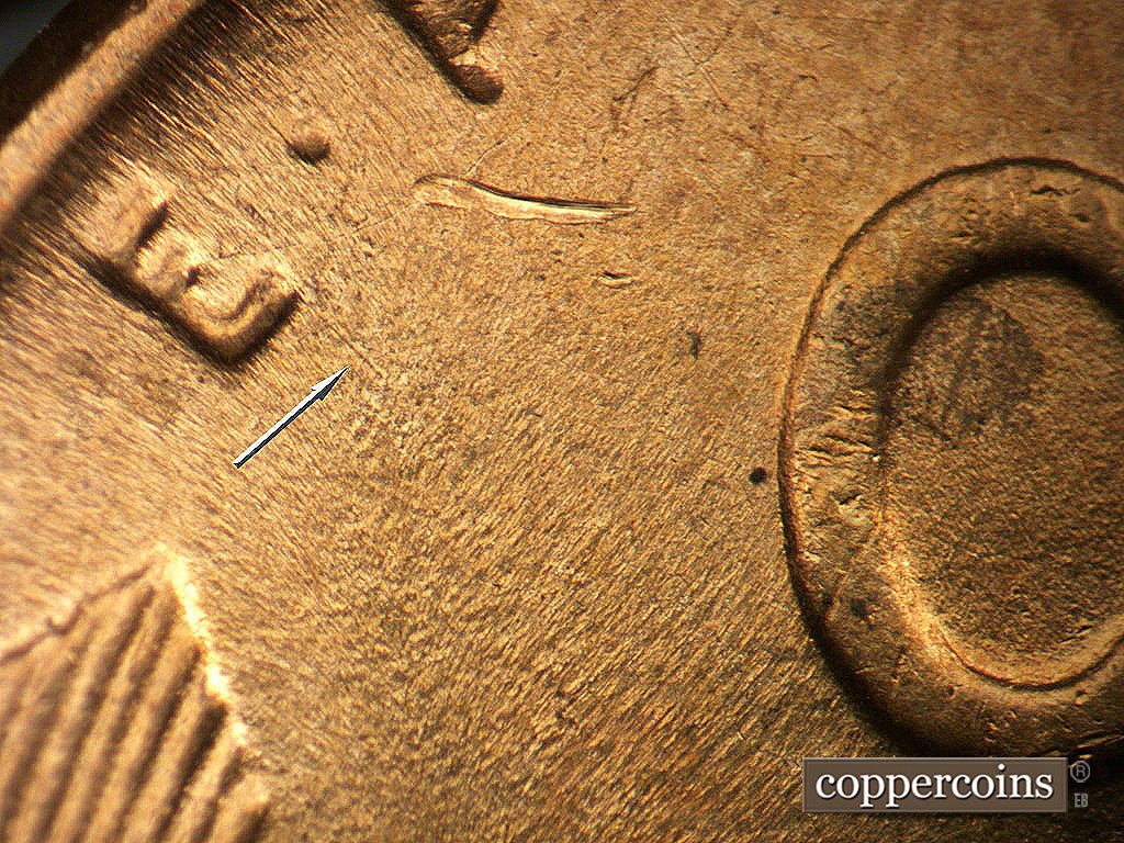 Die-stage B marker on 1944D•1MM•024 showing A light die scratch from the E of the motto.