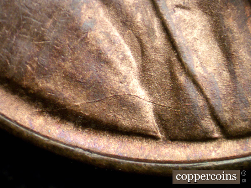 Die-stage A marker on 1944D•1OM•002 showing Die crack across shoulder.