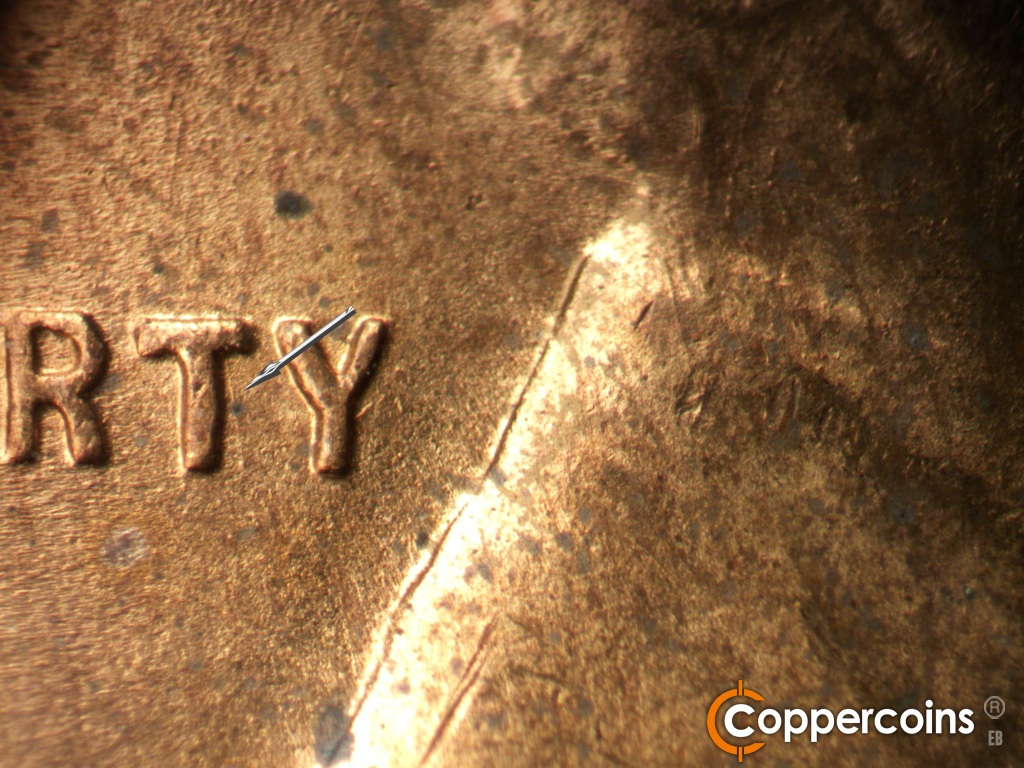 Die-stage B marker on 1944D•1OM•002 showing SSE die scratch from top right of T in LIBERTY.