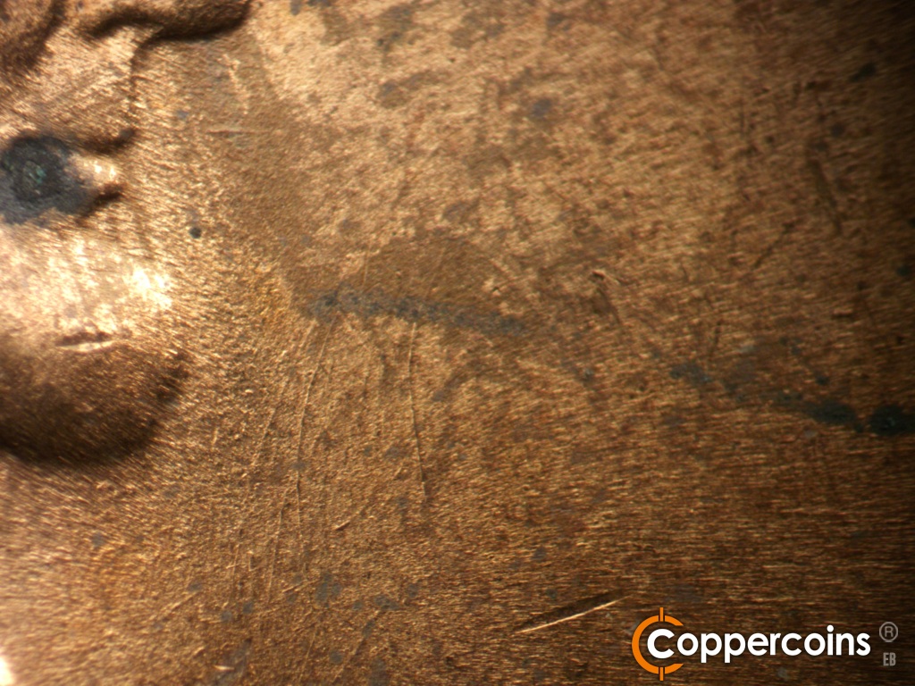 Die-stage B marker on 1944D•1OM•002 showing Die scratches in front of beard.