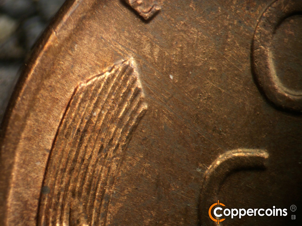 Die-stage B marker on 1944D•1OM•002 showing SE die scratches from top of left wheat stalk toward C in CENT.