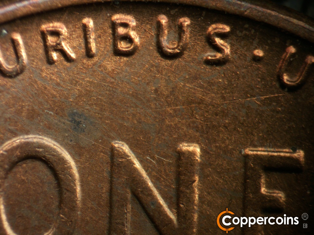 Die-stage B marker on 1944D•1OM•002 showing Die scratches across the upper field on the reverse.