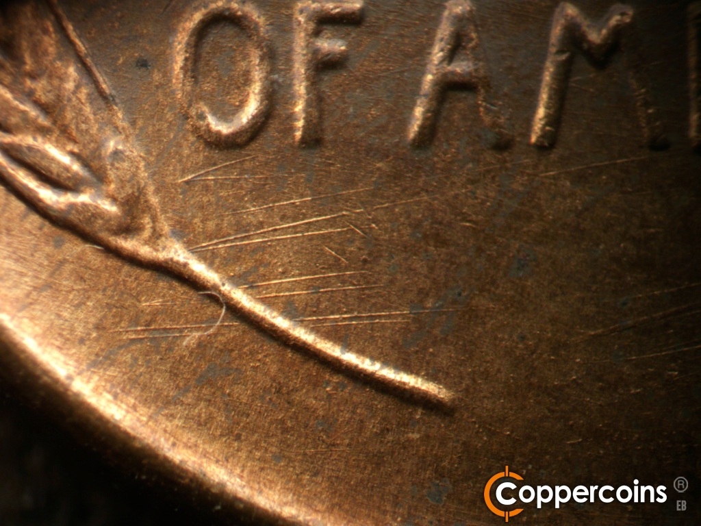 Die-stage B marker on 1944D•1OM•002 showing Heavier die scratches through the left wheat stem.