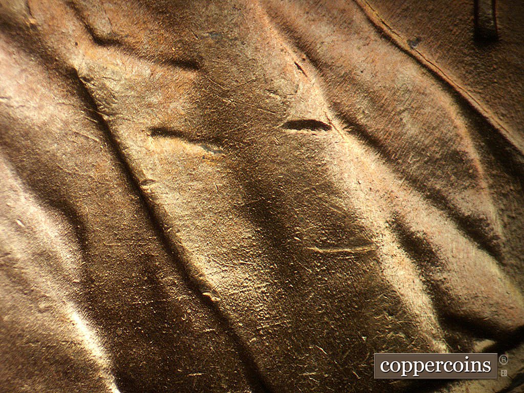 Die-stage B marker on 1944P•1DO•038 showing Concentric die scratches across lapel.