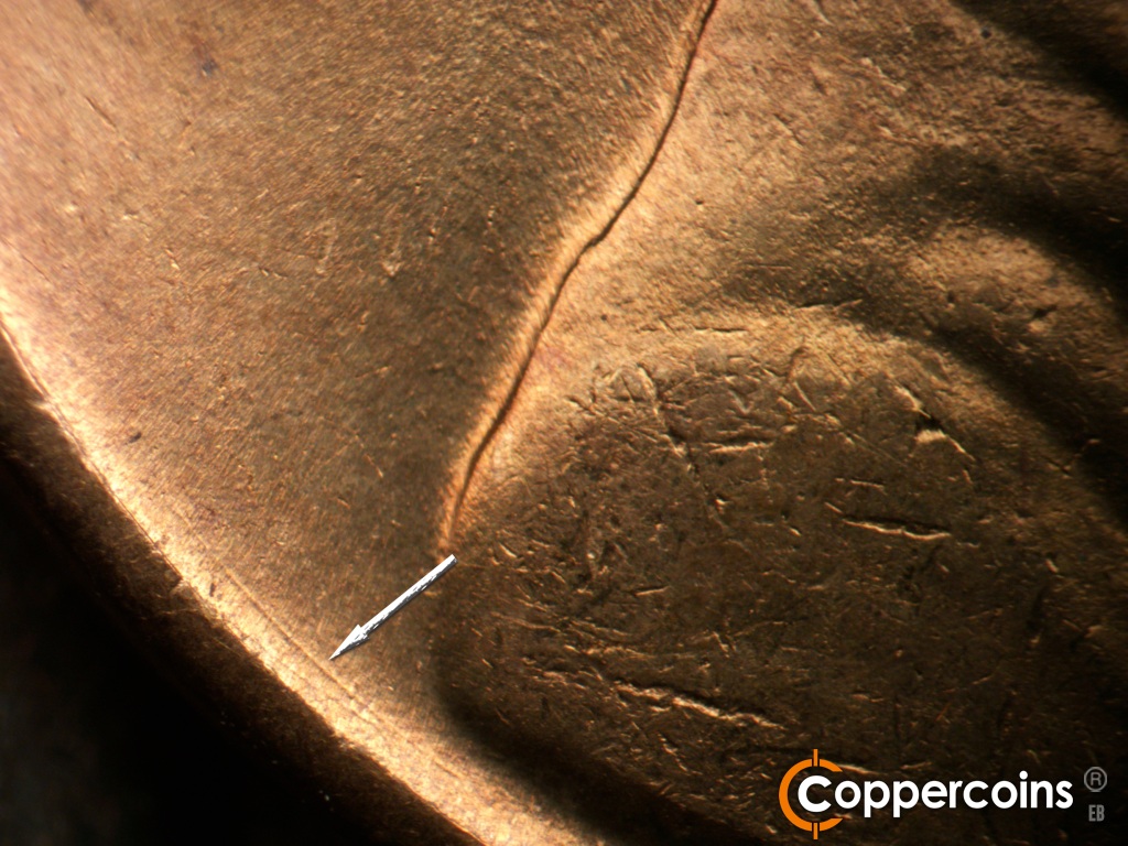 Die-stage C marker on 1944S•1MM•004 showing Die scratches near base of shoulder.