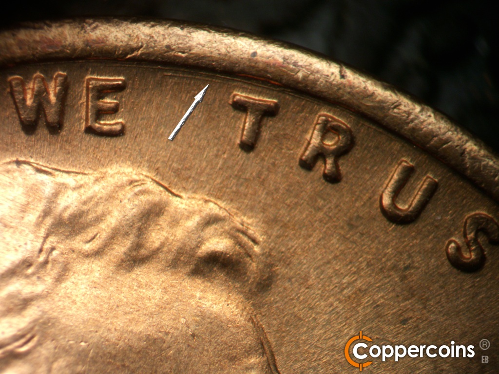 Die-stage C marker on 1944S•1MM•004 showing Concentric die scratch between rim and TRUST.