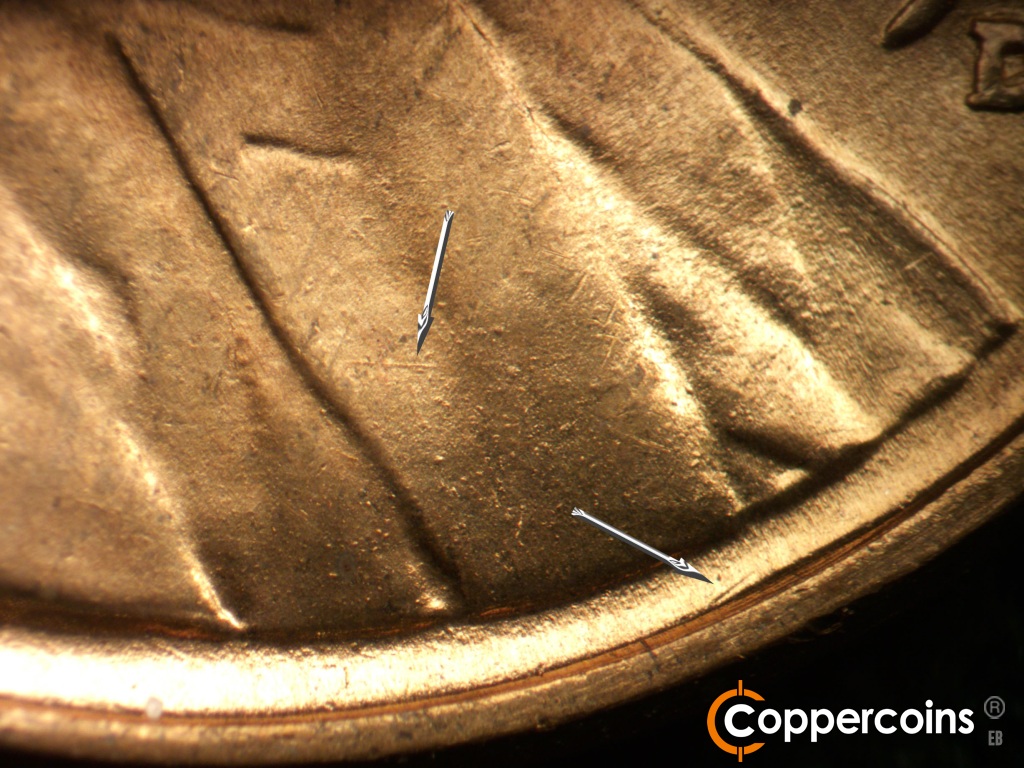 Die-stage A marker on 1945D•1MM•005 showing A small die gouge below the center of the bust on the rim. E/W die scratch on lapel.