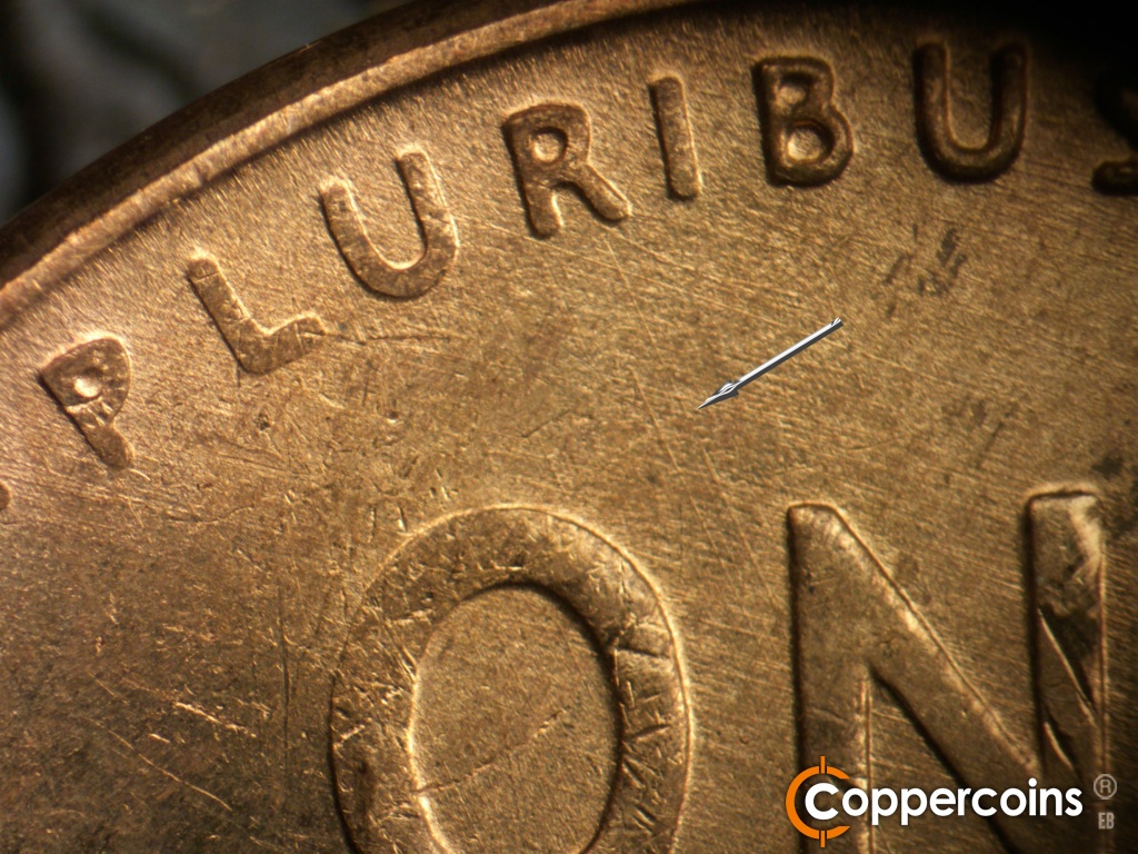 Die-stage A marker on 1945D•1MM•005 showing Light parallel die scratches from the 1st U of PLIURIBUS to the N of ONE. ESE die scratches cover upper left of reverse.