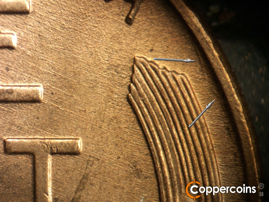 Die-stage A marker on 1945D•1MM•005 showing A N/S die gouge next to the rim to the east of the right wheat stalk.