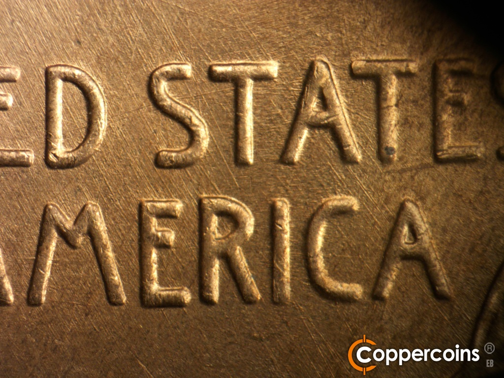 Die-stage A marker on 1945D•1MM•005 showing Curved die scratch through STA in STATES. SE die scratches in field around STATES and AMERICA.