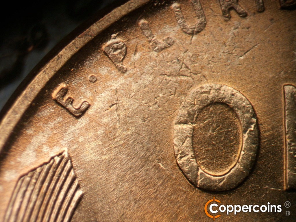 Die-stage B marker on 1945P•1DO•013 showing Light ENE die scratches through E in motto.