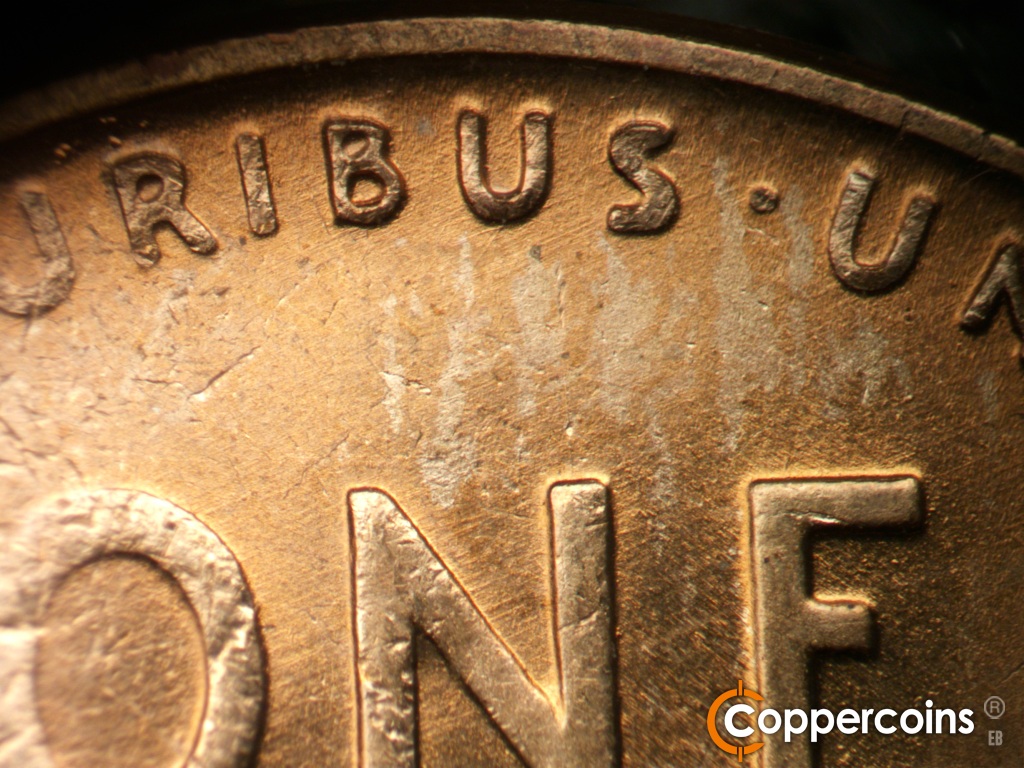 Die-stage B marker on 1945P•1DO•013 showing ENE die scratches through PLURIBUS.