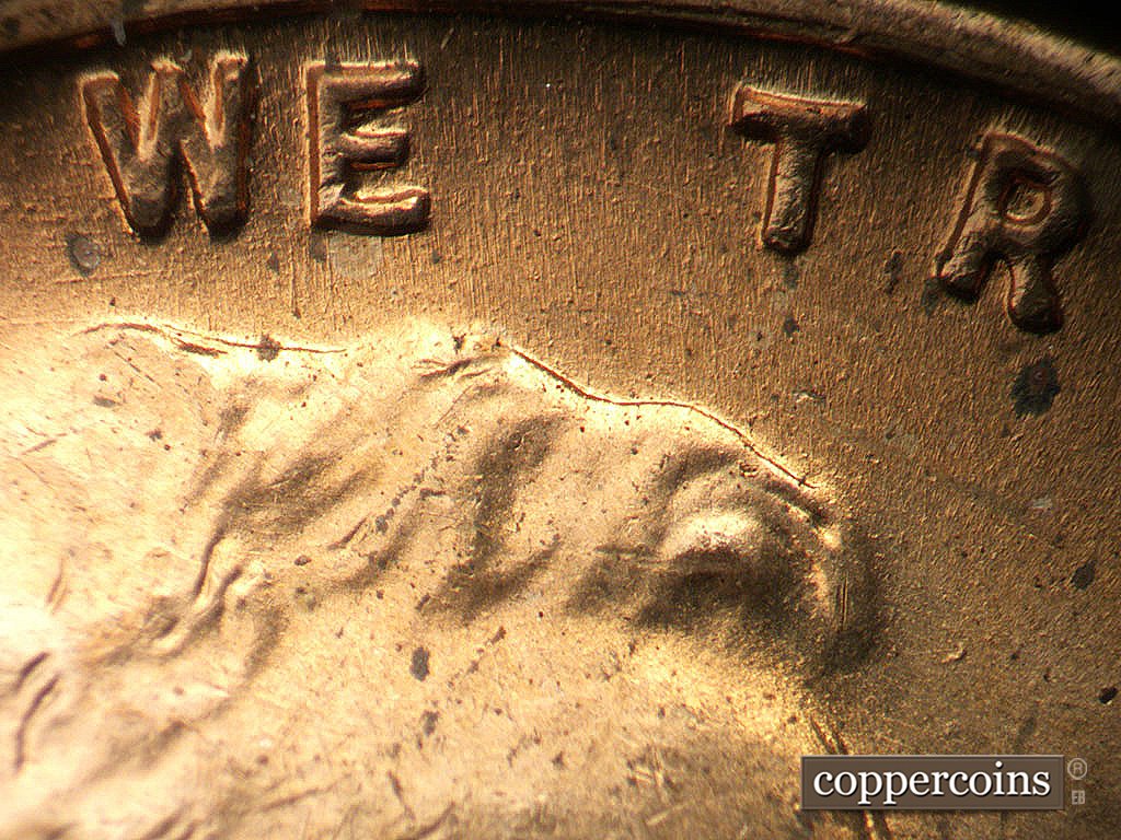 Die-stage A marker on 1945P•1DO•023 showing E/W die scratches near W in WE.