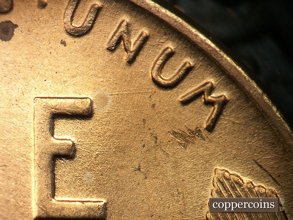 Die-stage A marker on 1945P•1DO•023 showing E/W die scratch connect E in ONE to second U in UNUM.