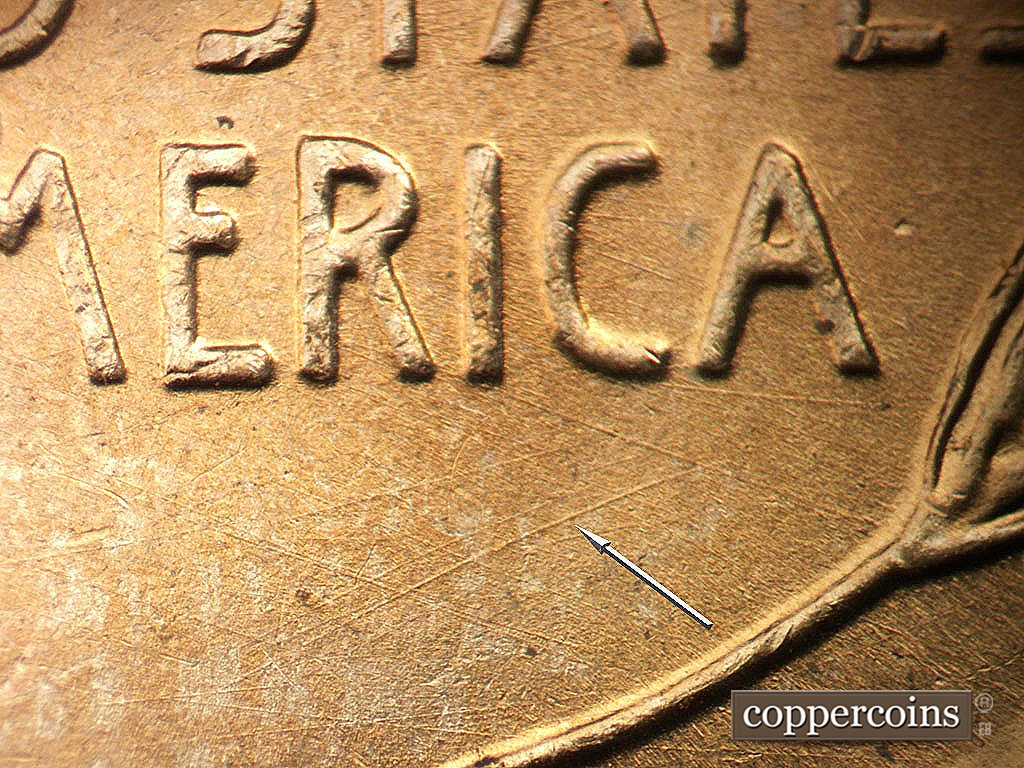 Die-stage A marker on 1945P•1DO•023 showing NE die scratch under RIC in AMERICA. SE die scratches under CA in AMERICA.