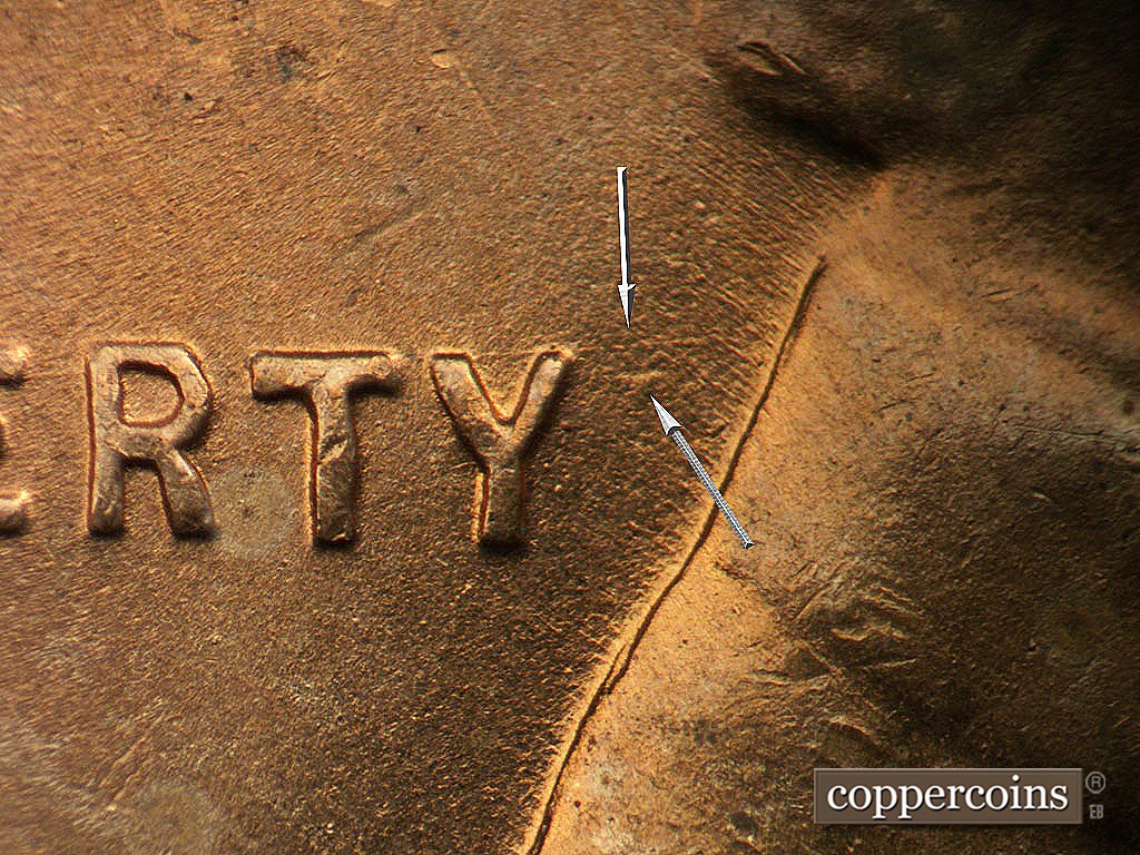 Die-stage B marker on 1945P•1DO•024 showing Die gouge near Y in LIBERTY, Light E/W die scratch from Y in LIBERTY to collar.