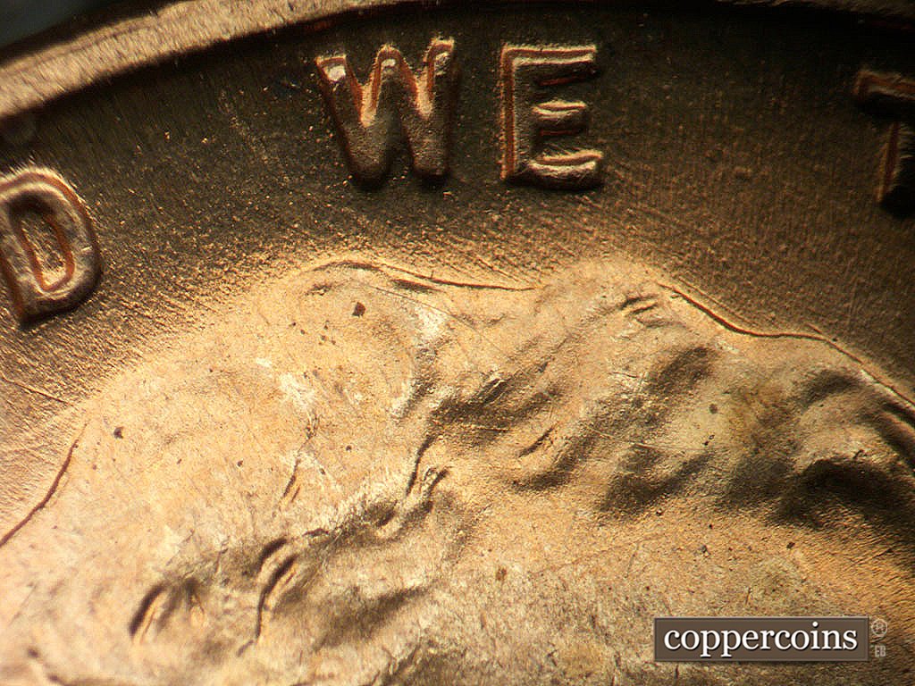 Die-stage B marker on 1945P•1DO•024 showing NW die scratches from top of head.